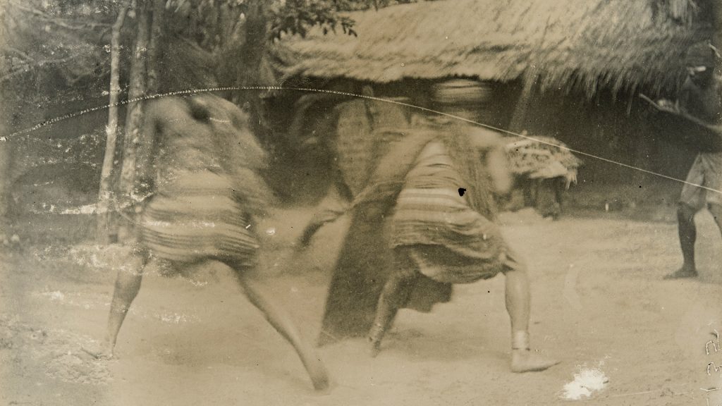 Men displaying fighting techniques, Awka. Photographed by Northcote Thomas in 1911.