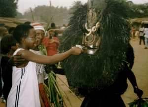 Chiadikobi Nwaubani and Ekpo masquerade in Umuahia, Nigeria.