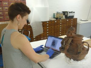 Object-based research at the Museum of Archaeology and Anthropology, University of Cambridge. Katrina Dring, Collections Assistant, documenting Olukun pot (Z 12112) collected by N. W. Thomas probably in Benin City, 1909.